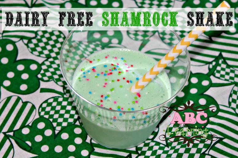 Non Dairy Shamrock shake with a white and yellow straw and sprinkles.